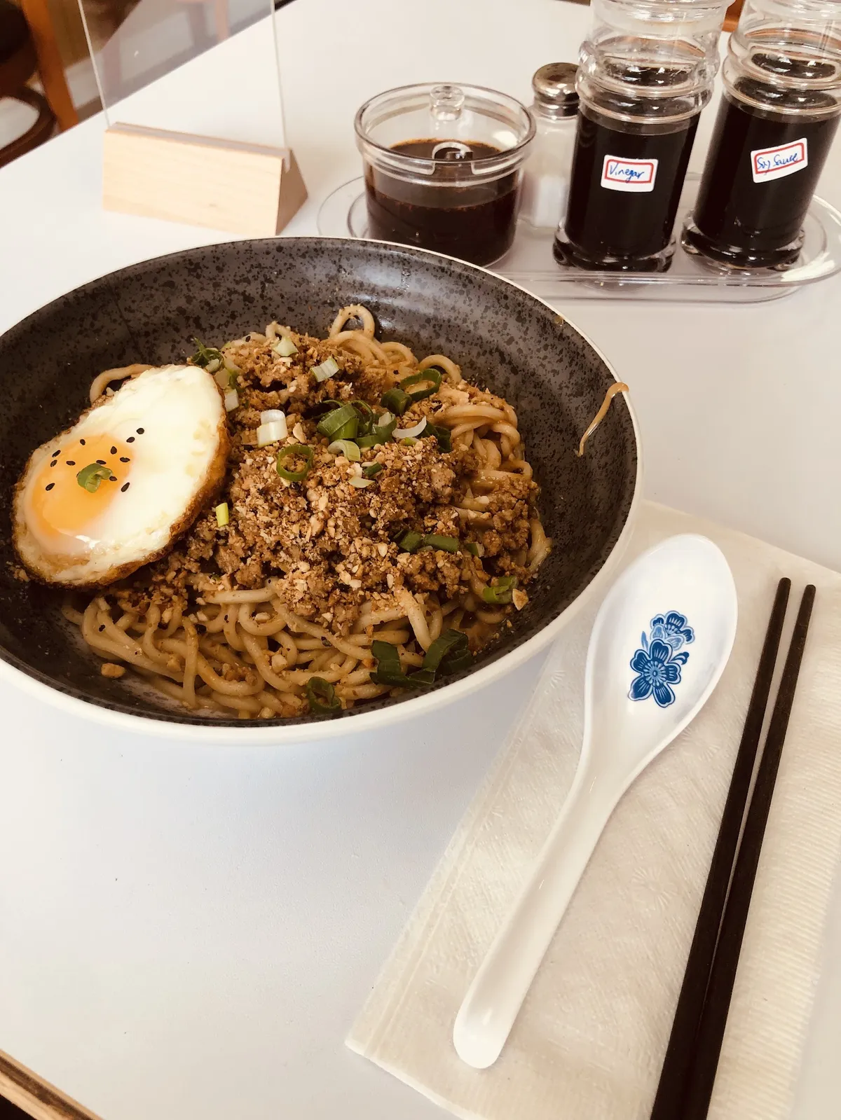 Bowl of noodles with ground meat and fried egg